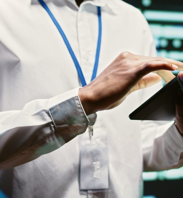 Admin in cloud computing business walking through server clusters used for computationally intensive tasks such as weather simulations. Supervisor doing yearly equipment inspection, close up